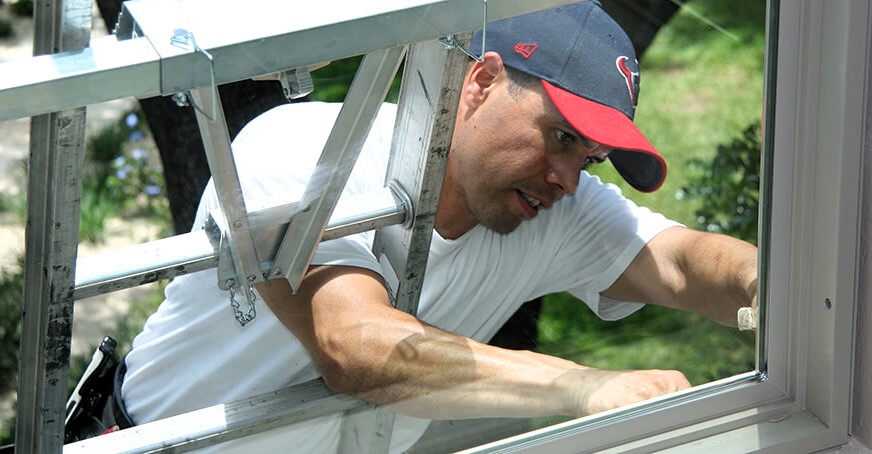 A Ringer Windows team member installing a window in an Austin home