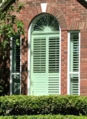An arched, non-operable window in the center with side flanking single-hung windows. And BetterVue Screens on the bottom!
