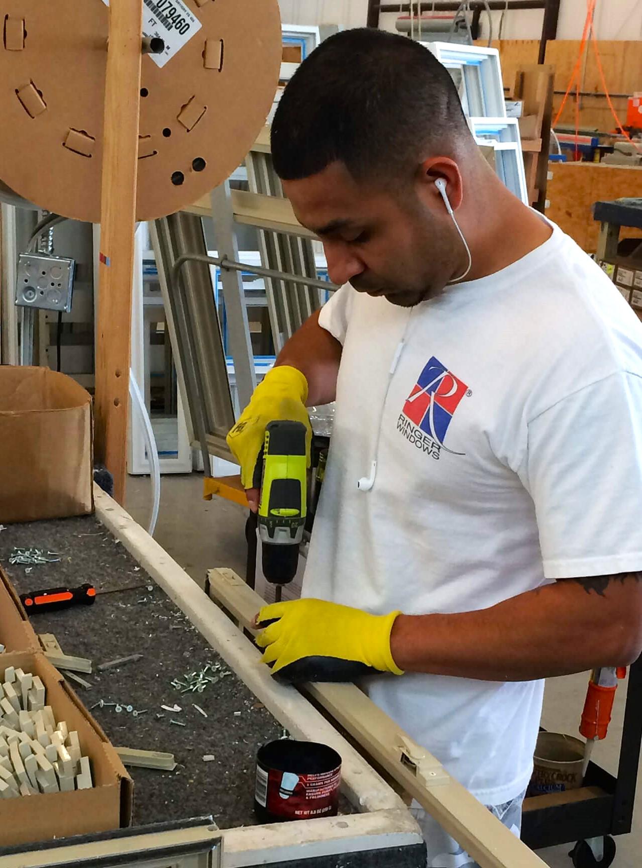 Ringer Windows employee, Lupe, building a window sash